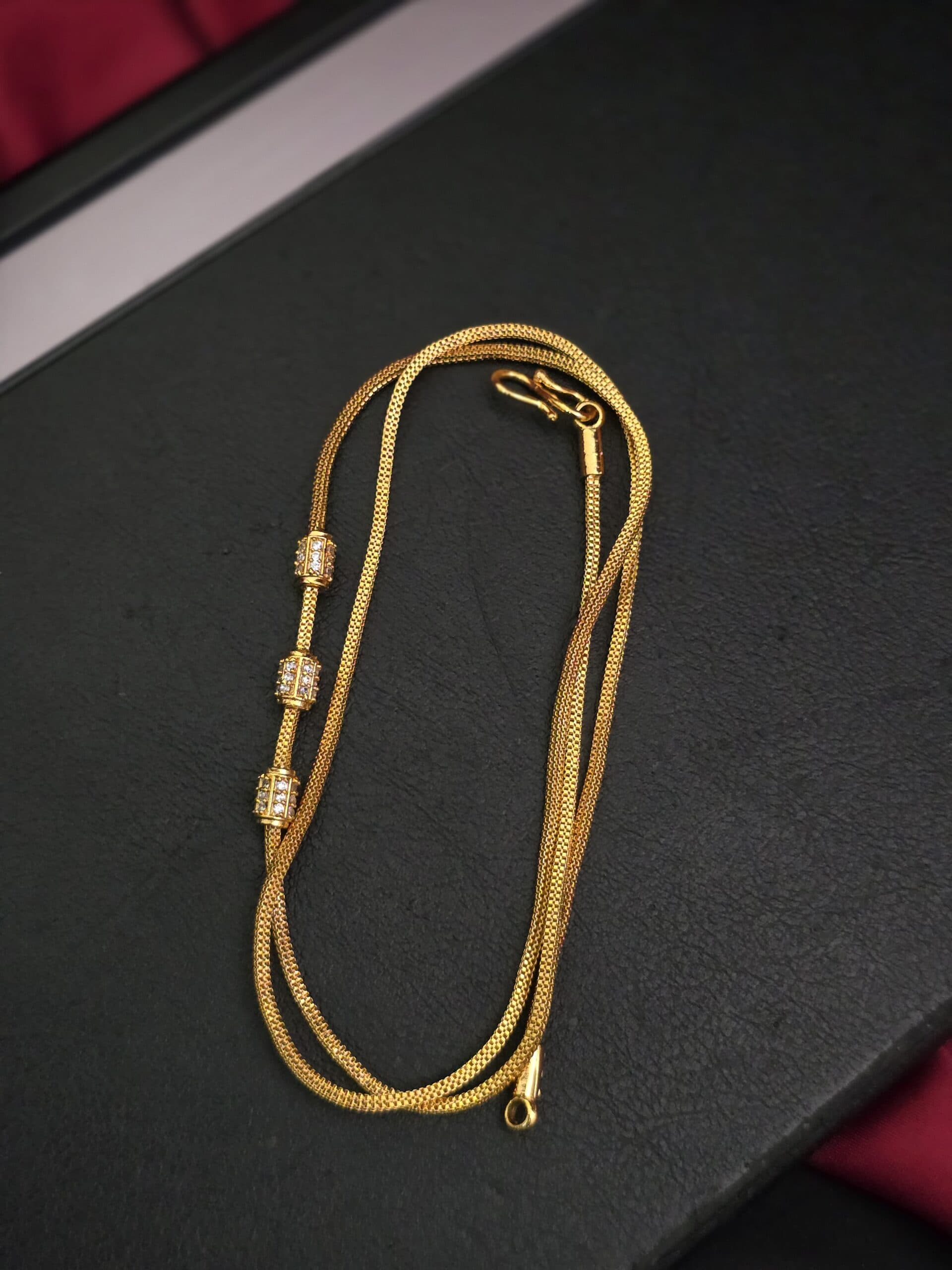 Real gold tone cylinder type mugappu chain